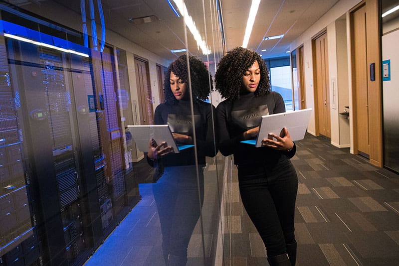 data security employee next to data servers